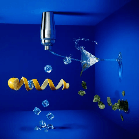 Cocktail glass with lemons in blue room